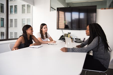 Women discussing/interviewing  